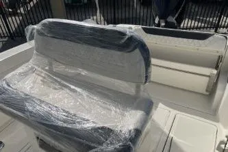 Slide: The Image of 2023 Trophy T24 CC boat seat wrapped in protective plastic, showcasing new condition. - 11