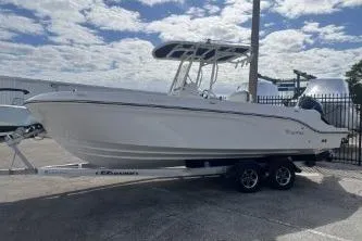 Slide: The Image of 2023 Trophy T24 CC boat on trailer under cloudy sky. - 5