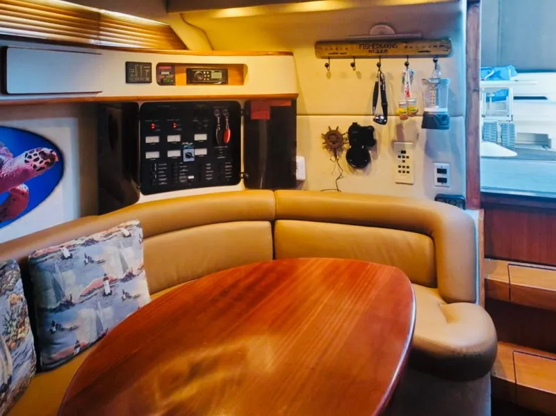 Slide: The Image of Interior of 1994 Sea Ray 400 Express Cruiser with cozy seating and control panel. - 10