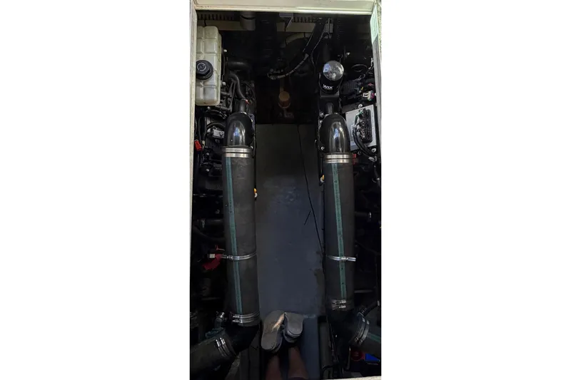 Slide: The Image of Engine room of a 1994 Sea Ray 400 Express Cruiser, showcasing dual exhaust systems. - 13