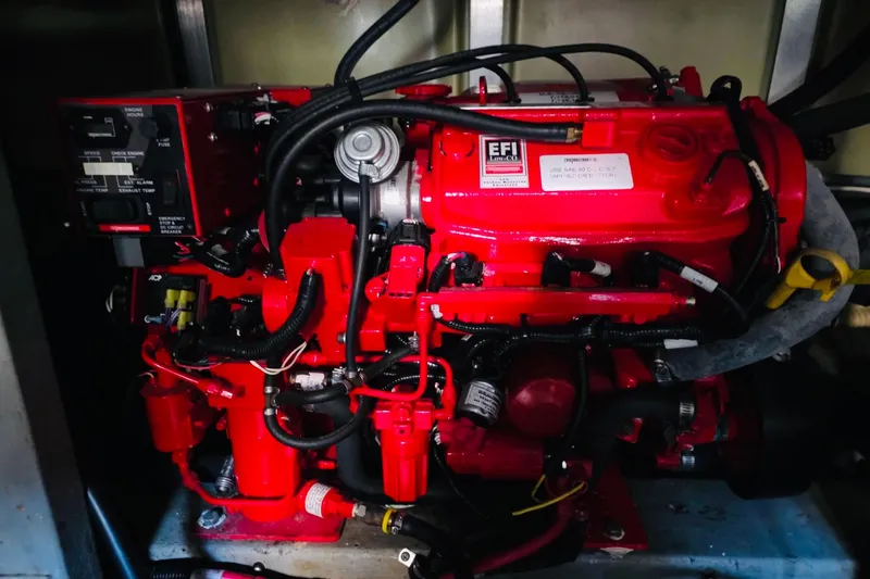 Slide: The Image of Engine of 1994 Sea Ray 400 Express Cruiser, featuring red components and wiring. - 14