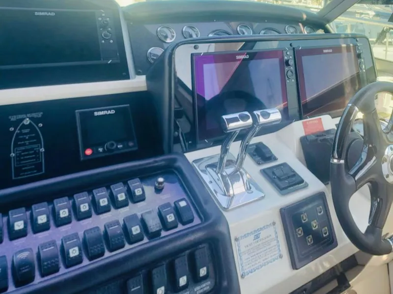 Slide: The Image of 1994 Sea Ray 400 Express Cruiser dashboard with modern navigation controls and dual Simrad displays. - 3