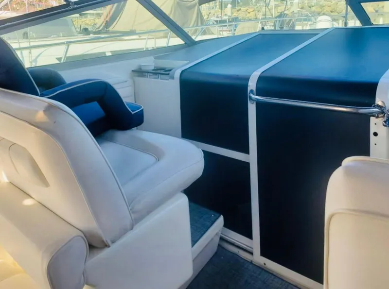 Slide: The Image of Interior of 1994 Sea Ray 400 Express Cruiser with white seating and blue accents. - 4
