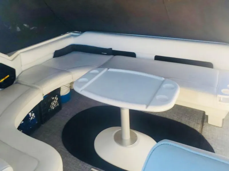 Slide: The Image of 1994 Sea Ray 400 Express Cruiser interior with white seating and table. - 5