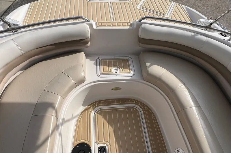 Slide: The Image of 2001 Hurricane SunDeck 237 OB boat interior with beige seating and deck. - 12