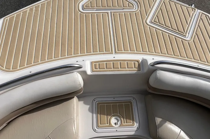 Slide: The Image of 2001 Hurricane SunDeck 237 OB boat interior with beige seating and deck. - 13