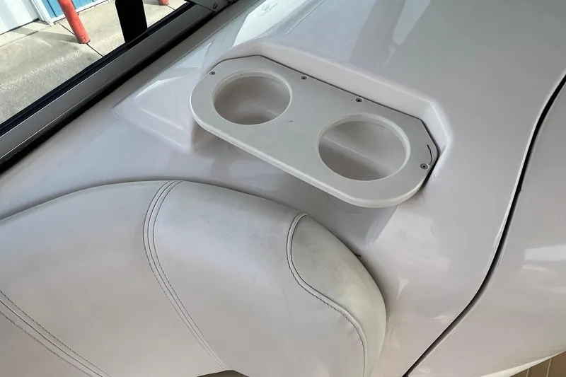 Slide: The Image of 2001 Hurricane SunDeck 237 OB boat interior with cup holders and white seating. - 14