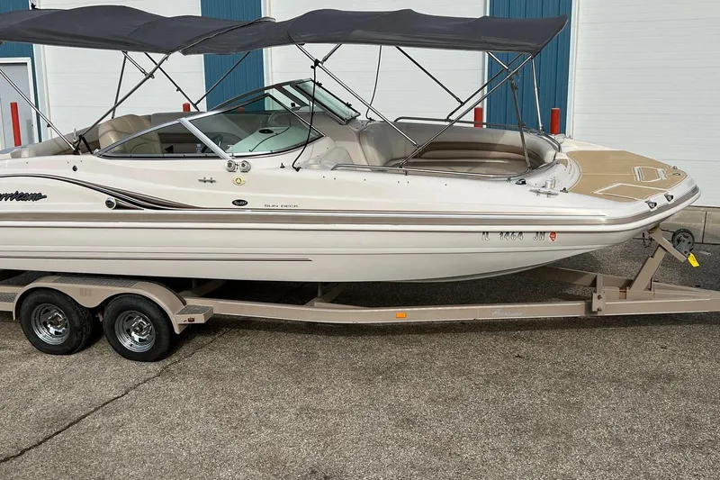 Slide: The Image of 2001 Hurricane SunDeck 237 OB boat on trailer, featuring dual bimini tops. - 17