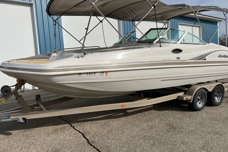 Slide: The Image of 2001 Hurricane SunDeck 237 OB boat on trailer, parked outdoors with canopy. - 5
