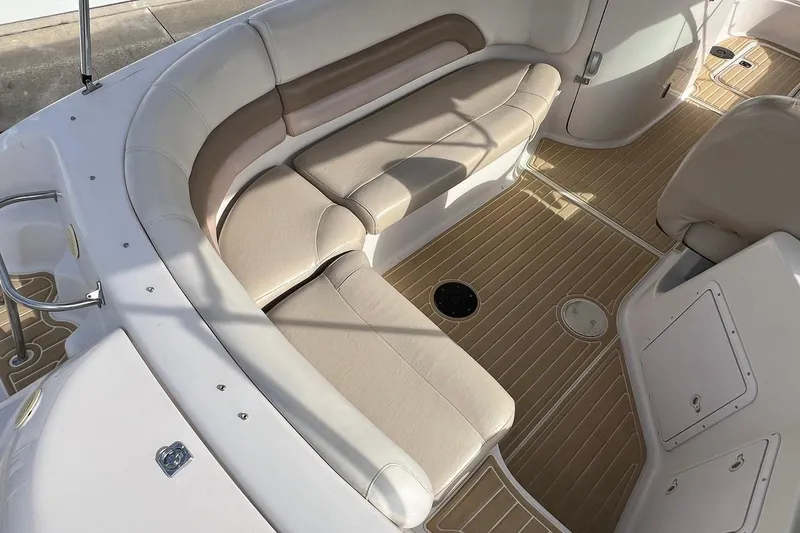 Slide: The Image of 2001 Hurricane SunDeck 237 OB boat interior with beige seating and wood-patterned flooring. - 8