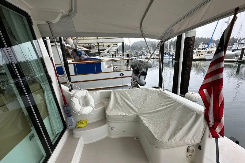 Slide: The Image of 2010 Back Cove 37 yacht cruising on open water with scenic mountain backdrop. - 10