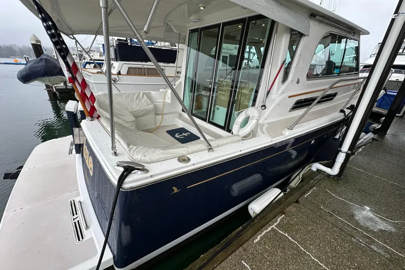 Slide: The Image of 2010 Back Cove 37 cruising on open water with mountains in the background. - 11