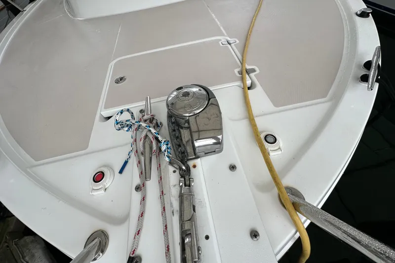 Slide: The Image of 2010 Back Cove 37 yacht cruising on open water, featuring sleek design and American flag. - 13