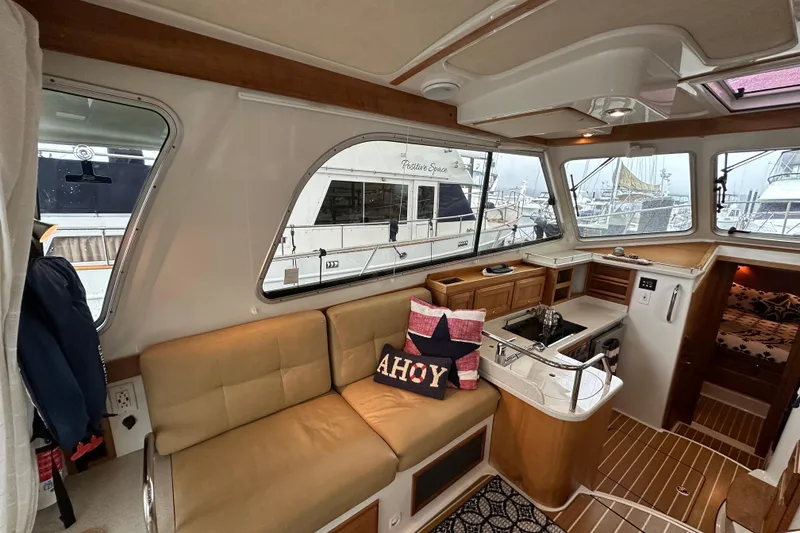 Slide: The Image of 2010 Back Cove 37 yacht cruising on open water, showcasing sleek design and craftsmanship. - 16