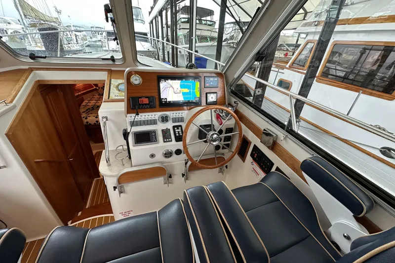 Slide: The Image of 2010 Back Cove 37 yacht cruising on open water, creating a wake. - 21