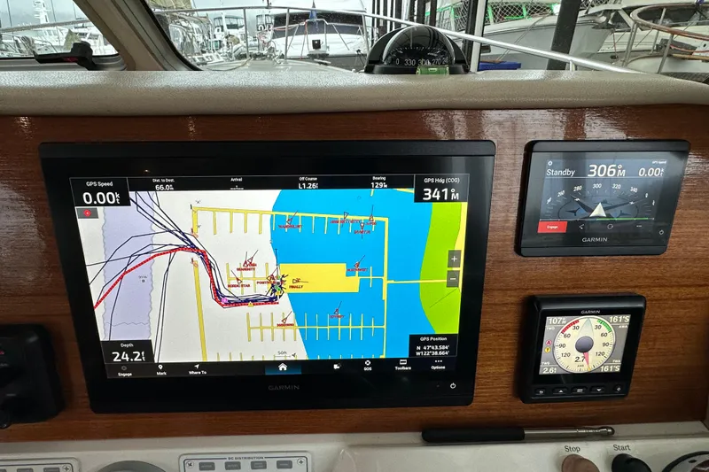 Slide: The Image of 2010 Back Cove 37 yacht cruising on calm waters under a cloudy sky. - 24