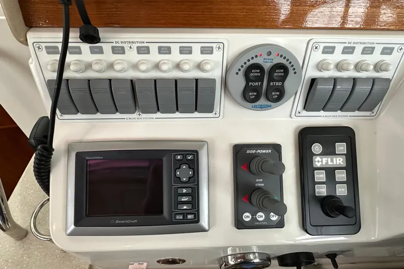 Slide: The Image of 2010 Back Cove 37 yacht with striped seating, open cabin, and scenic water view. - 26