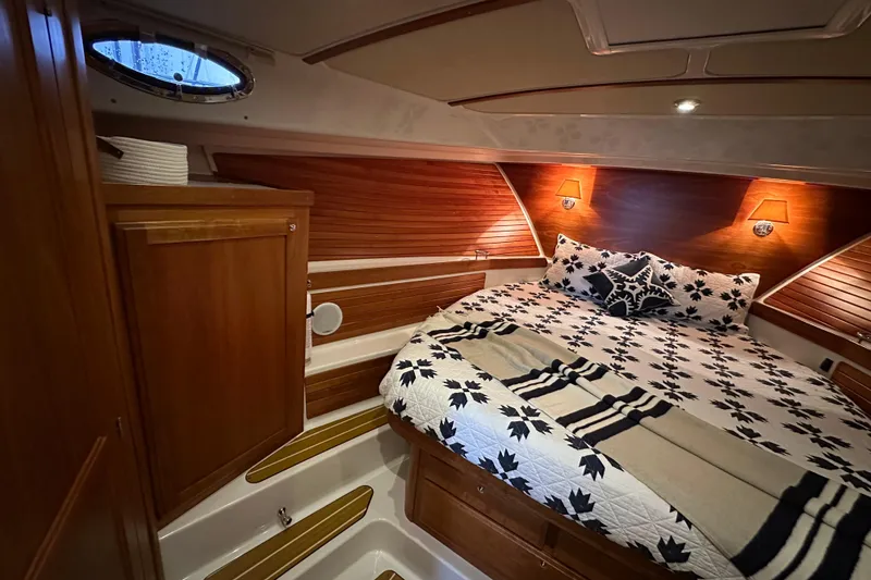 Slide: The Image of 2010 Back Cove 37 yacht interior with mounted Jensen TV and wooden cabinetry. - 32