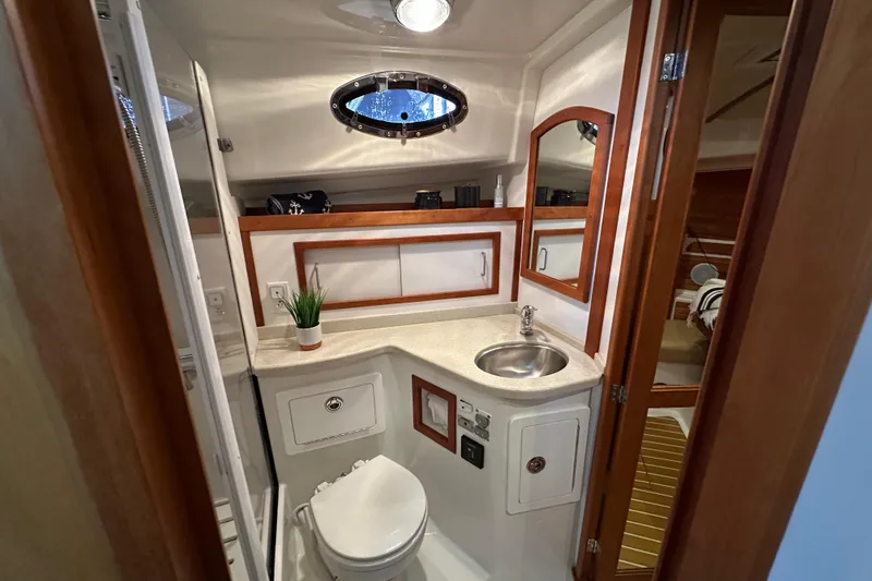 Slide: The Image of Control panel of a 2010 Back Cove 37 boat with throttle and navigation display. - 37