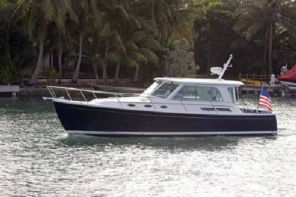 Slide: The Image of 2010 Back Cove 37 boat cruising on calm water at sunset. - 4