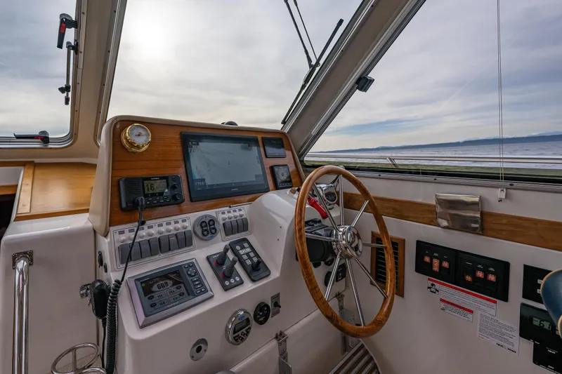 Slide: The Image of 2010 Back Cove 37 boat helm with navigation instruments and steering wheel. - 47