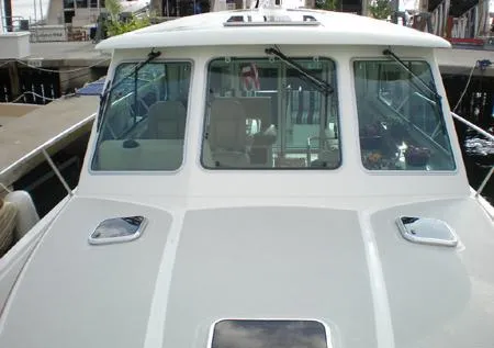 Slide: The Image of 2010 Back Cove 37 cruising on calm waters, showcasing sleek design and elegance. - 5