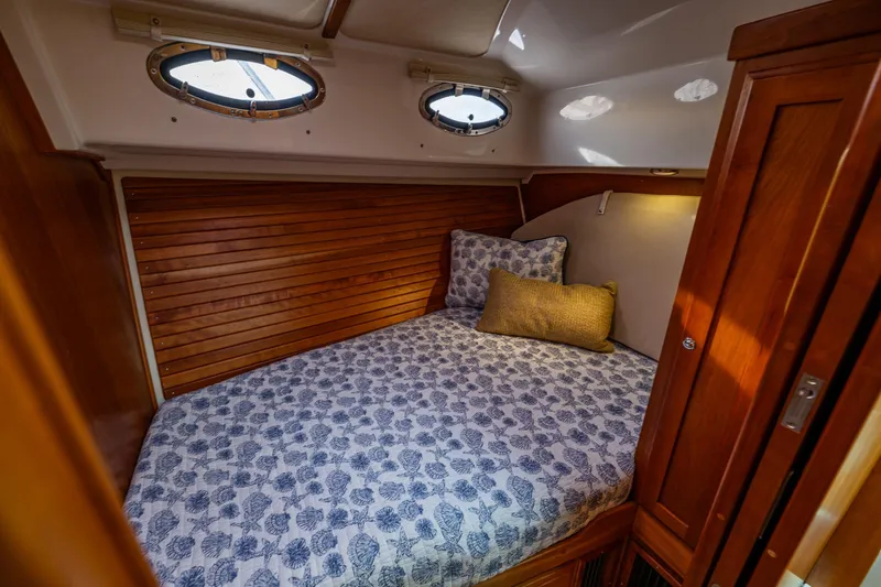 Slide: The Image of Cozy cabin interior of 2010 Back Cove 37 boat with wooden accents and patterned bedding. - 51