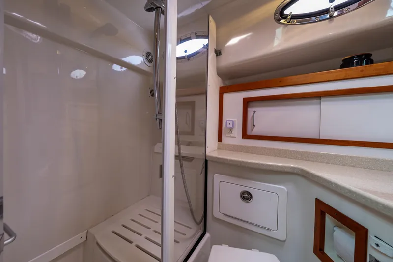 Slide: The Image of 2010 Back Cove 37 yacht bathroom with shower, sink, and storage cabinets. - 52