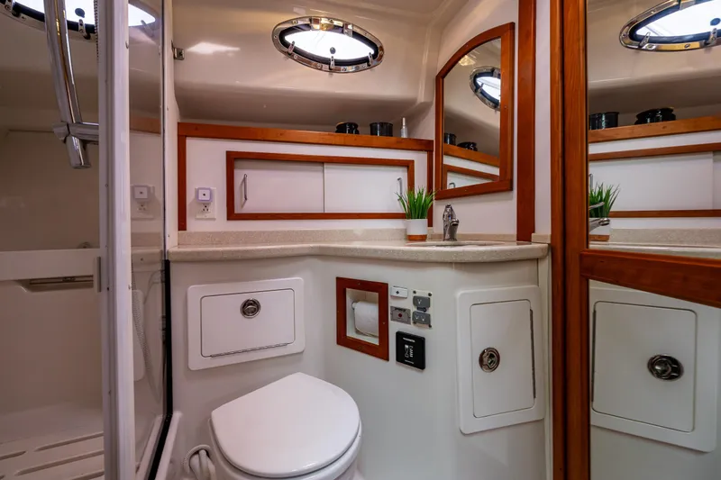 Slide: The Image of Luxurious bathroom in 2010 Back Cove 37 yacht with modern fixtures and wood accents. - 53