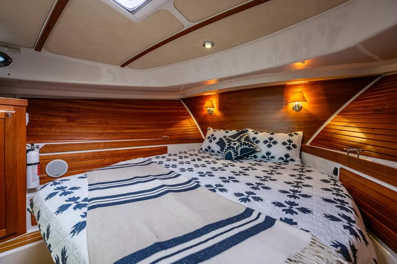 Slide: The Image of Luxurious cabin interior of 2010 Back Cove 37 yacht with cozy bedding and wooden accents. - 54