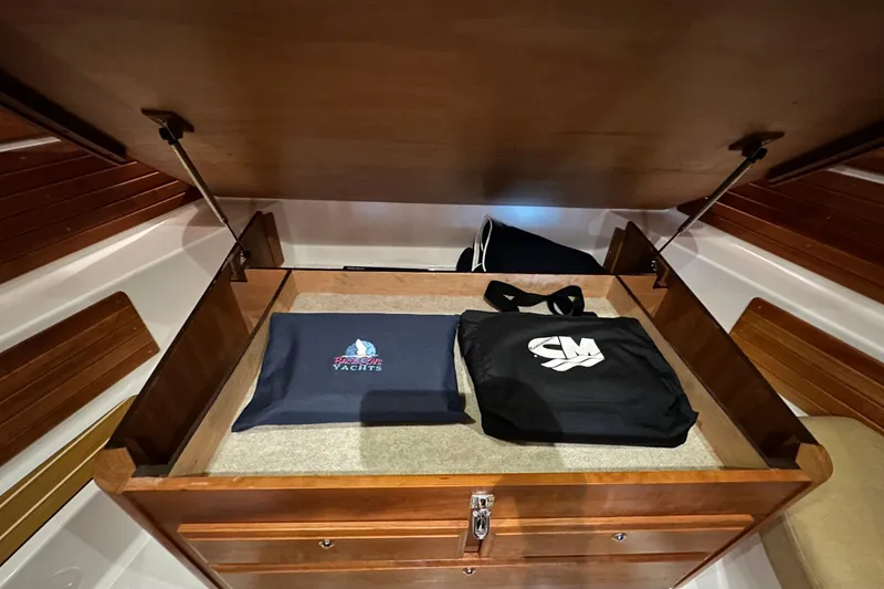 Slide: The Image of Storage compartment in a 2010 Back Cove 37 yacht with branded bags. - 56