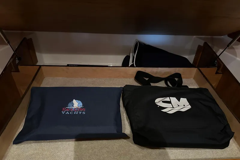 Slide: The Image of Storage compartment in a 2010 Back Cove 37 yacht with branded bags. - 57