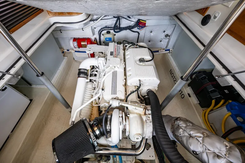 Slide: The Image of Engine compartment of a 2010 Back Cove 37 boat, featuring a clean, organized layout. - 59