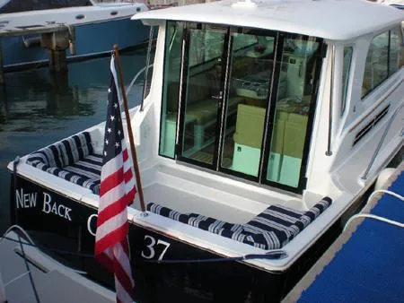 Slide: The Image of 2010 Back Cove 37 boat cruising on calm water. - 6