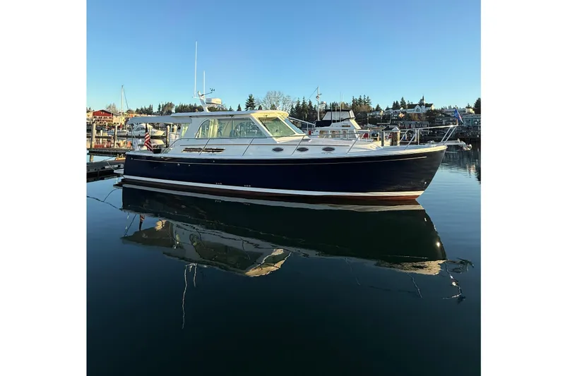 Slide: The Image of 2010 Back Cove 37 yacht docked in serene marina under clear blue sky. - 69
