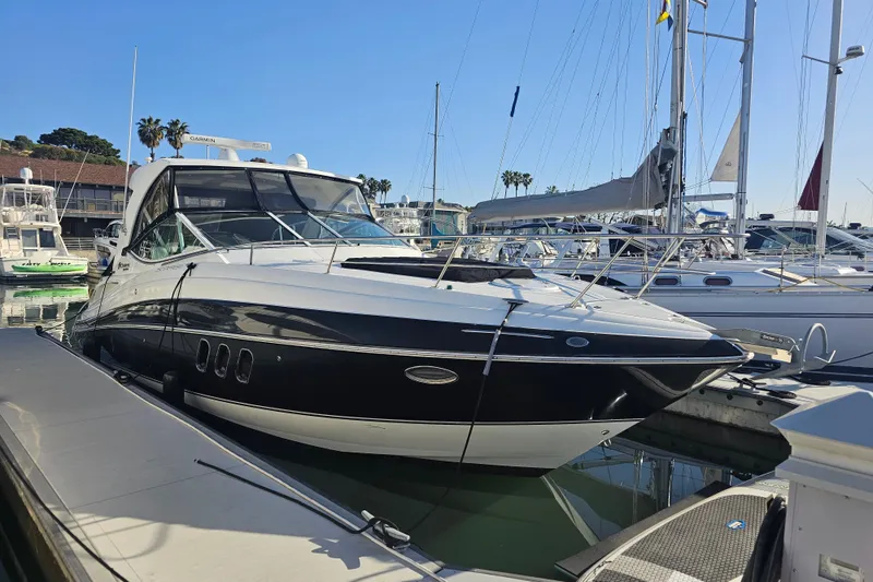 The Image of 2012 Cruisers Yachts 350 Express docked at marina, surrounded by sailboats. - 0