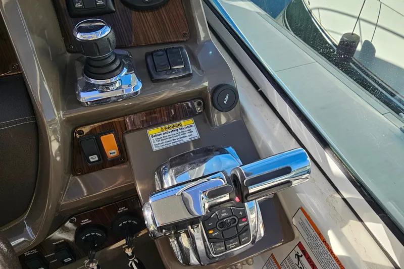Slide: The Image of Control panel of a 2012 Cruisers Yachts 350 Express with joystick and throttle levers. - 12