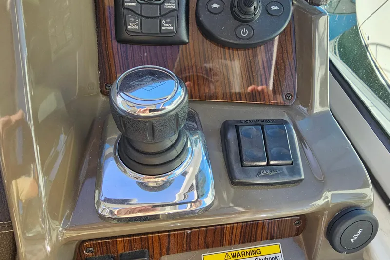 Slide: The Image of Control panel of 2012 Cruisers Yachts 350 Express with joystick and switches. - 13