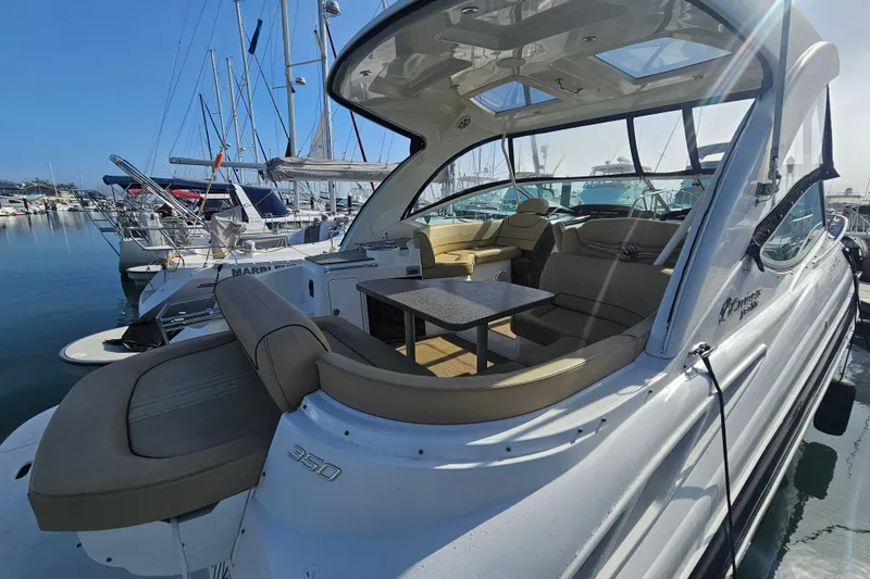 Slide: The Image of 2012 Cruisers Yachts 350 Express docked, showcasing spacious seating and sleek design. - 14