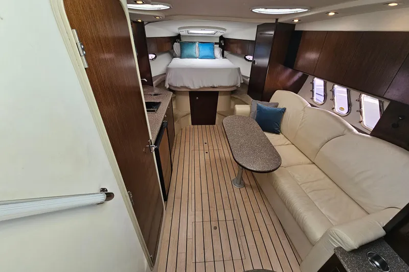 Slide: The Image of Interior of 2012 Cruisers Yachts 350 Express, featuring elegant wood finishes and comfortable seating. - 20