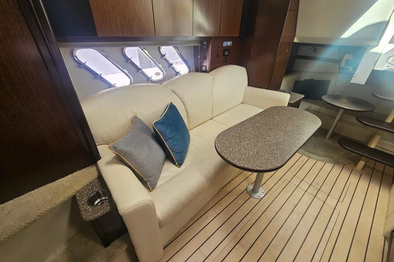 Slide: The Image of Interior of 2012 Cruisers Yachts 350 Express with sofa, table, and porthole windows. - 22