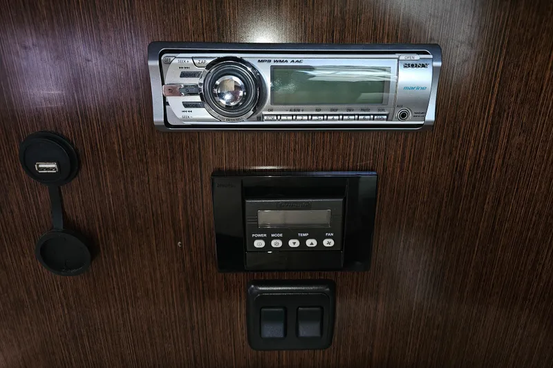 Slide: The Image of 2012 Cruisers Yachts 350 Express dashboard with Sony marine stereo and control panel. - 25