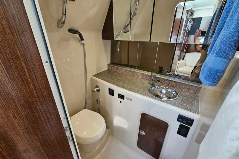 Slide: The Image of 2012 Cruisers Yachts 350 Express bathroom with shower, sink, and toilet. - 29