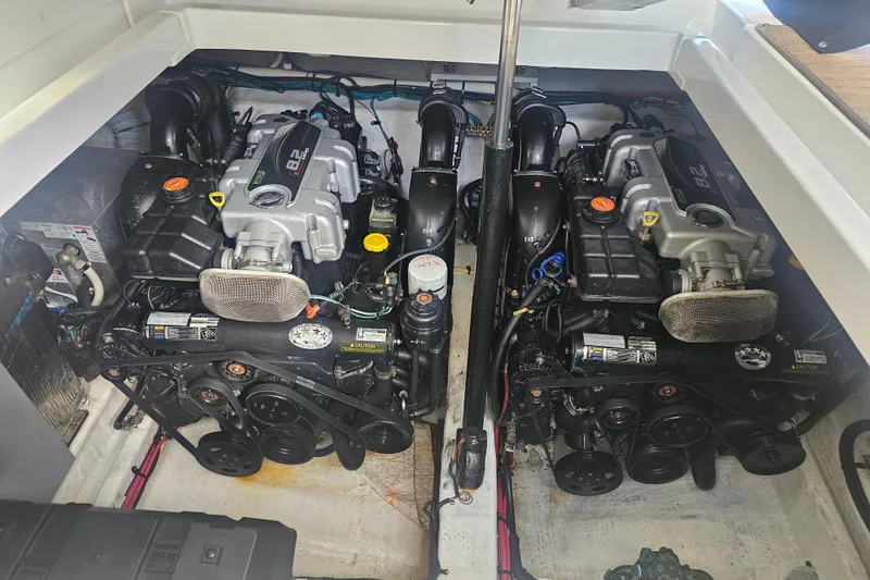 Slide: The Image of Engine compartment of a 2012 Cruisers Yachts 350 Express, featuring dual inboard engines. - 30