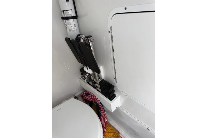 Slide: The Image of Interior of 2025 Sea Hunt Ultra 265 SE boat, featuring a compact storage area. - 13