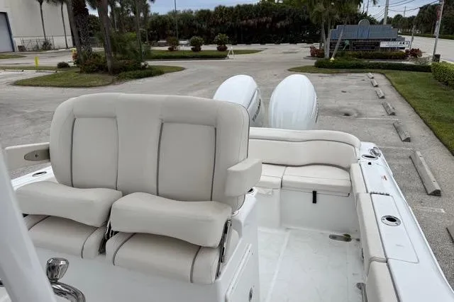 Slide: The Image of 2025 Sea Hunt Ultra 265 SE boat interior with plush seating and dual engines. - 17