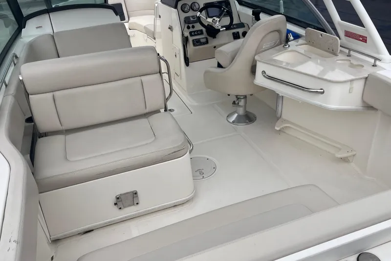 Slide: The Image of 2015 Boston Whaler 230 Vantage interior with seating and helm station. - 12