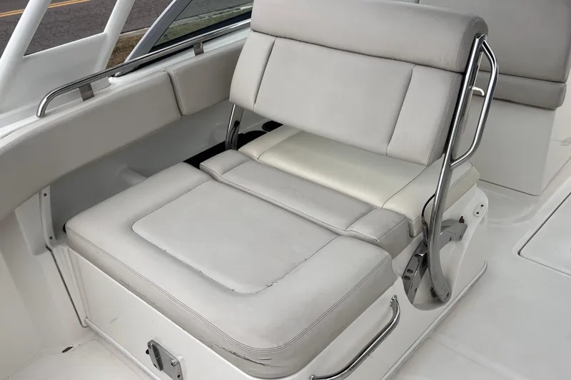 Slide: The Image of 2015 Boston Whaler 230 Vantage boat seat with stainless steel armrests. - 14