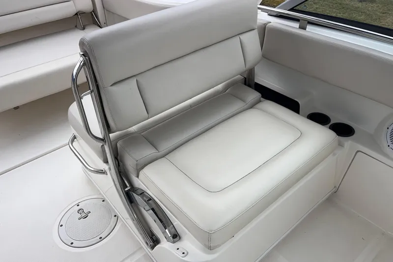 Slide: The Image of 2015 Boston Whaler 230 Vantage boat interior with white cushioned seating. - 17