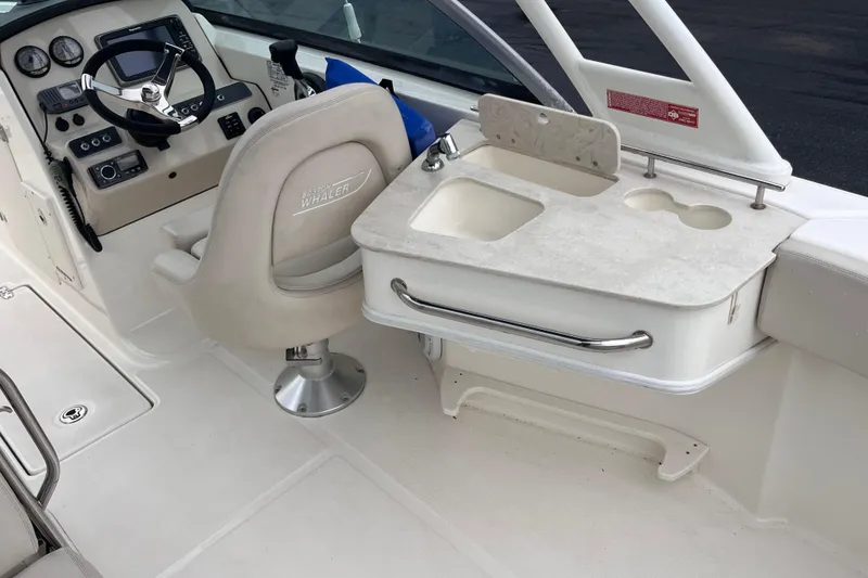 Slide: The Image of 2015 Boston Whaler 230 Vantage boat interior with helm and sink area. - 20